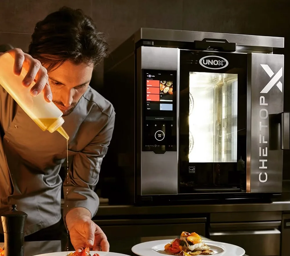 Chef plating beside a combi oven